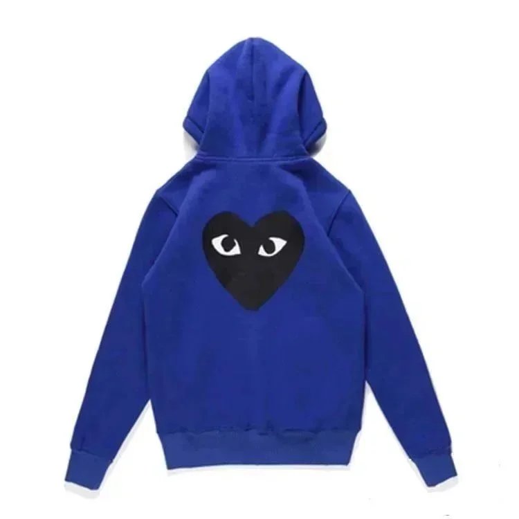 There is a big black heart behind the looped blue cardigan